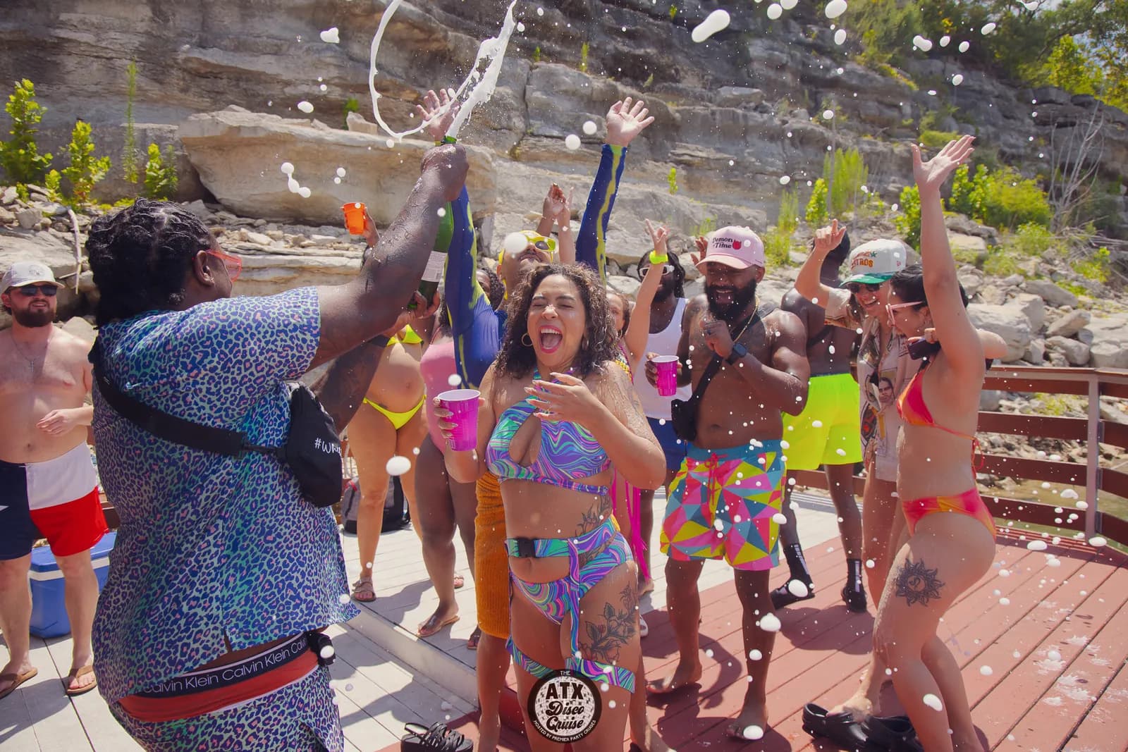 Guests dancing in a shower of confetti on a Lake Travis party boat